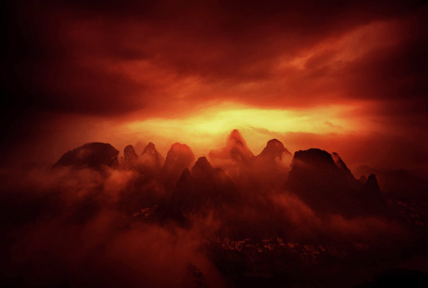 A moody landscape from China, heavily processed to enhance the mist and sunrise in its oranges and reds.